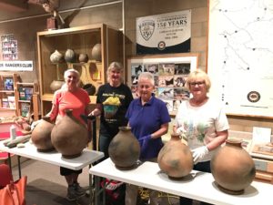 Archaeology volunteers with artifacts